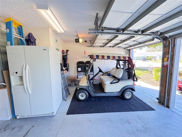 garage with white refrigerator with ice dispenser and a garage door opener