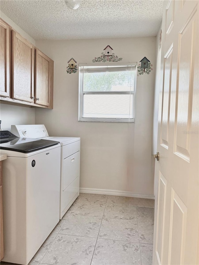 24614 Stillridge Ct, Leesburg, FL 34748 - washroom featuring washer and dryer, baseboards, a textured ceiling, and cabinet space