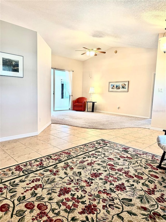 24614 Stillridge Ct, Leesburg, FL 34748 - interior space featuring light tile patterned floors, ceiling fan, a textured ceiling, lofted ceiling, and baseboards