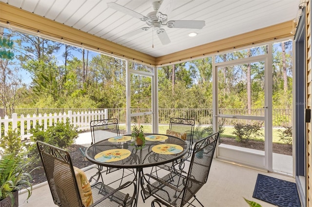 sunroom featuring a ceiling fan