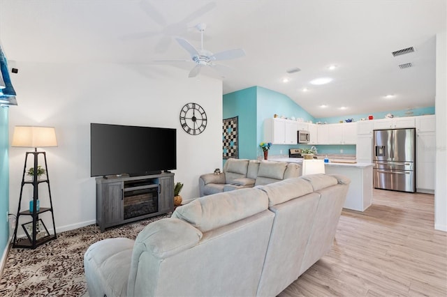 living area with visible vents, light wood-style flooring, a ceiling fan, recessed lighting, and vaulted ceiling