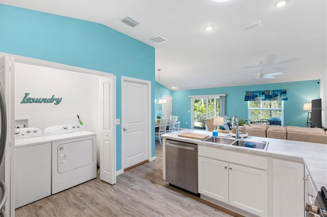 kitchen featuring vaulted ceiling, a sink, open floor plan, and stainless steel dishwasher