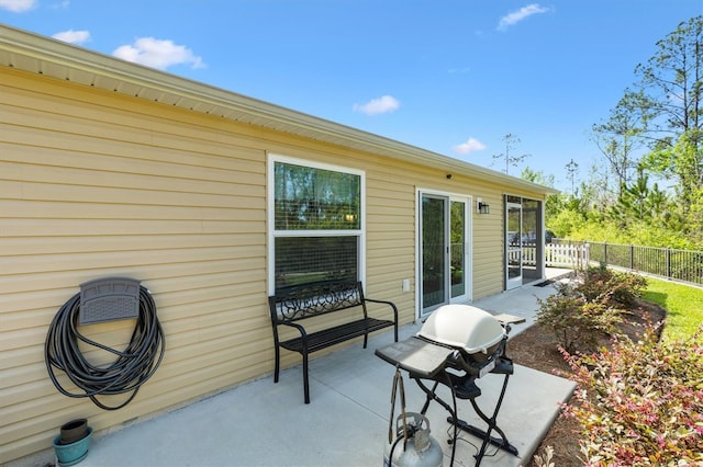 view of patio with grilling area and fence