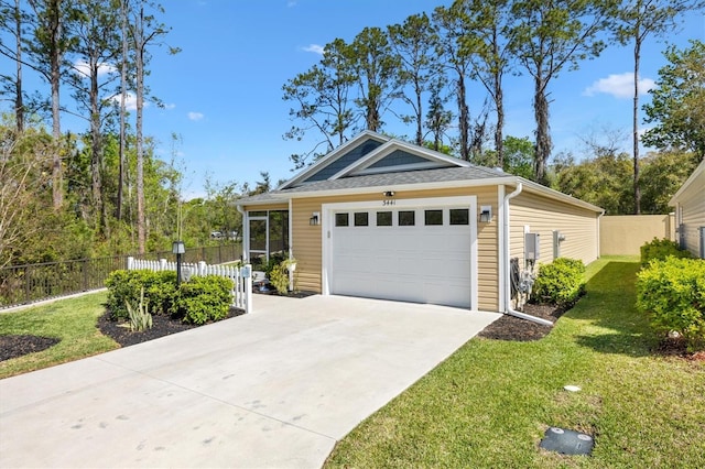 view of front facade featuring a front lawn, fence, roof with shingles, a garage, and driveway