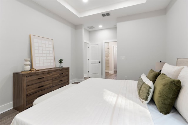 bedroom with visible vents, recessed lighting, baseboards, and wood finished floors