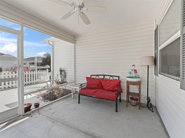 sunroom / solarium with a ceiling fan