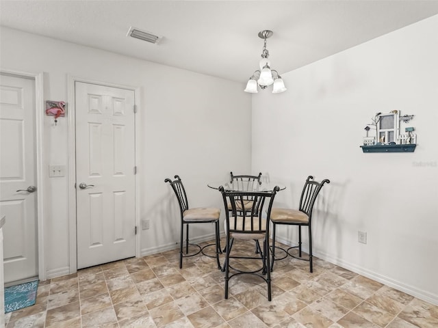 dining area featuring baseboards and visible vents