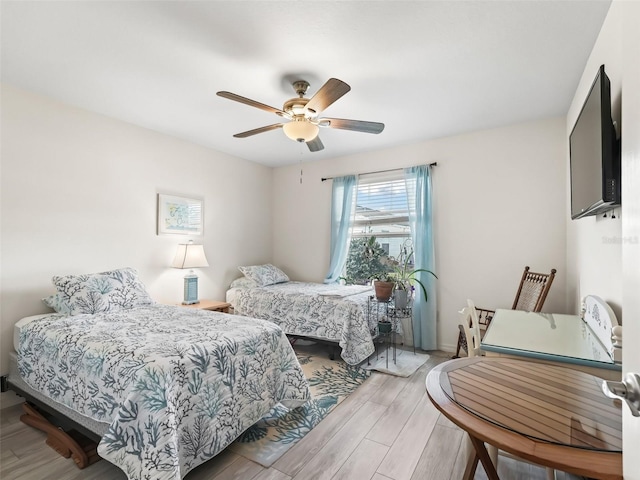 bedroom featuring light wood-style floors and ceiling fan