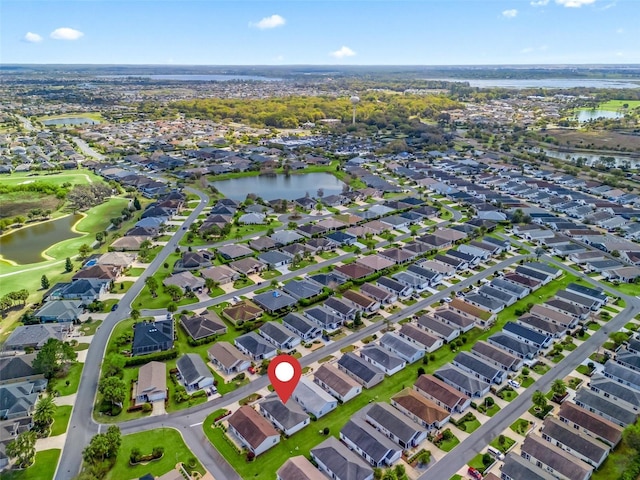 drone / aerial view featuring a residential view and a water view