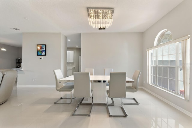 dining room with baseboards and a chandelier