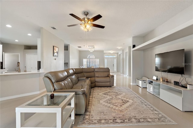 living area featuring baseboards, recessed lighting, visible vents, and ceiling fan