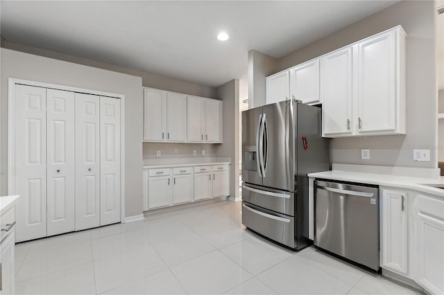 kitchen featuring light countertops, white cabinets, light tile patterned floors, and stainless steel appliances