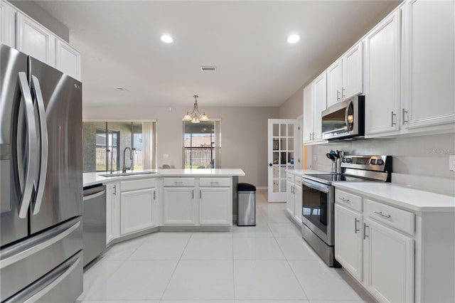 kitchen with visible vents, a sink, light countertops, appliances with stainless steel finishes, and white cabinetry