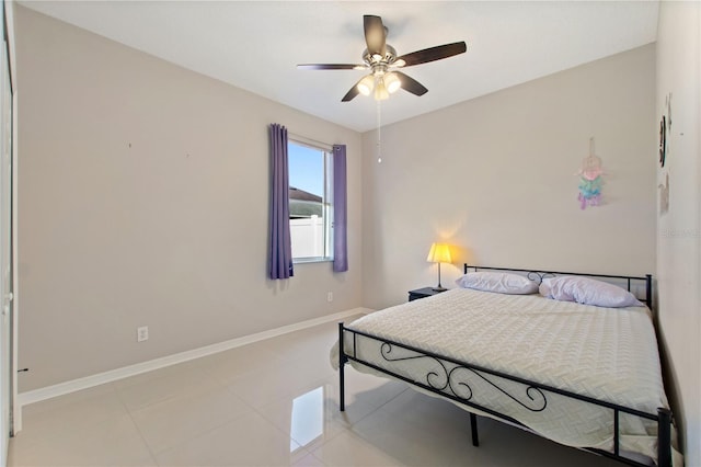 bedroom featuring light tile patterned floors, baseboards, and a ceiling fan