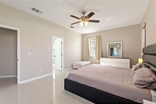 bedroom with light tile patterned floors, visible vents, baseboards, and a ceiling fan