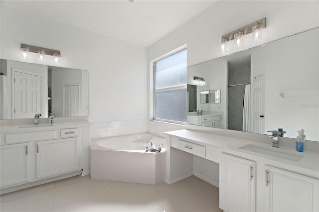 full bathroom featuring two vanities, a shower stall, a garden tub, and a sink