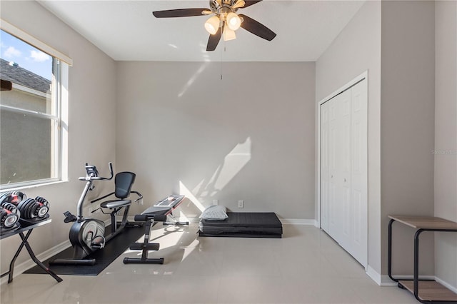 exercise room featuring ceiling fan and baseboards