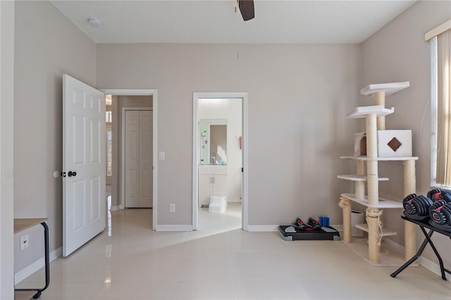 bedroom with connected bathroom and baseboards