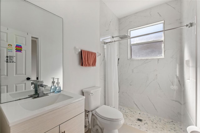 bathroom with a marble finish shower, toilet, and vanity