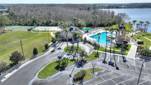 birds eye view of property featuring a wooded view and a water view