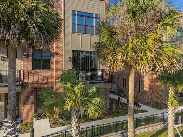 exterior space with brick siding and fence