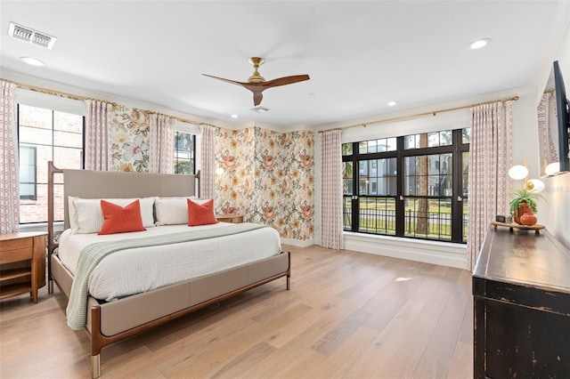 bedroom with wood finished floors, visible vents, a ceiling fan, wallpapered walls, and recessed lighting