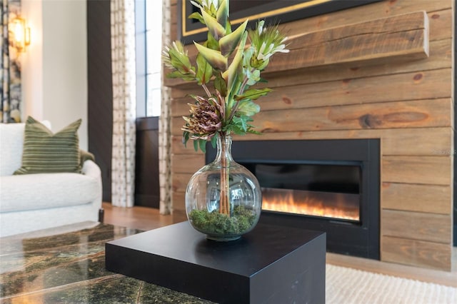 interior details with a glass covered fireplace