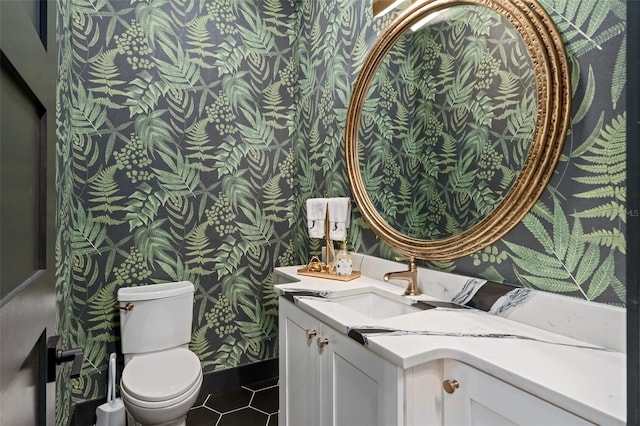 bathroom featuring toilet, vanity, and tile patterned flooring