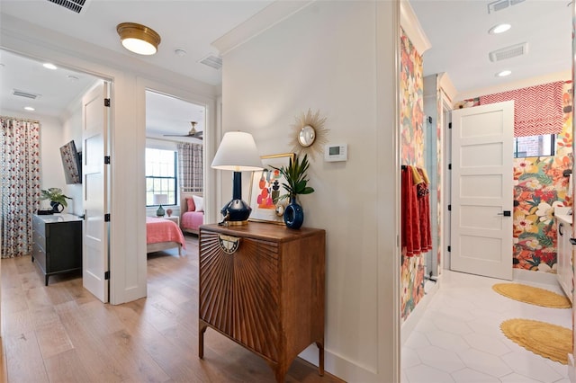 hallway with recessed lighting, visible vents, baseboards, and light wood-style floors