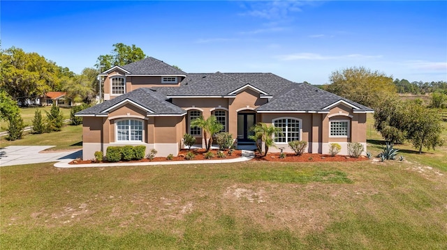 view of front of property with a front yard and stucco siding