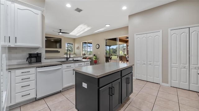 kitchen featuring a sink, white cabinets, ceiling fan, and white dishwasher