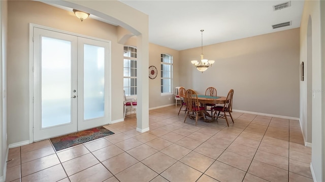 dining room featuring light tile patterned floors, french doors, visible vents, and a chandelier