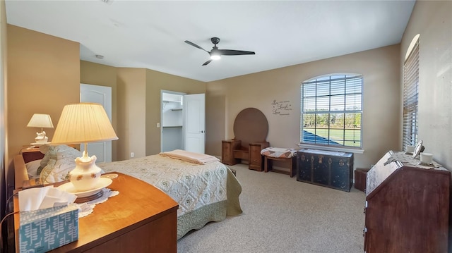 carpeted bedroom featuring a ceiling fan and a closet