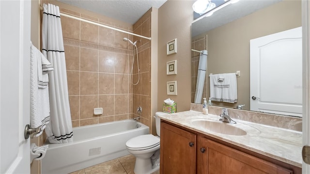 bathroom featuring tile patterned flooring, toilet, vanity, a textured ceiling, and shower / bathtub combination with curtain