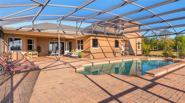 outdoor pool featuring ceiling fan, a patio, and a lanai