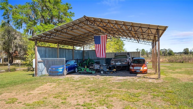 view of parking / parking lot featuring a carport and an outbuilding