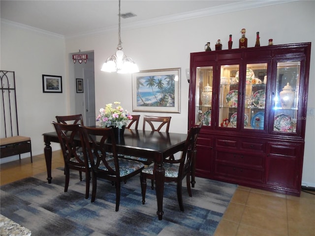 tiled dining room featuring an inviting chandelier, crown molding, and visible vents