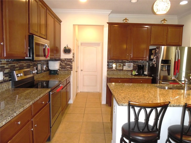 kitchen with light tile patterned floors, appliances with stainless steel finishes, crown molding, and a sink