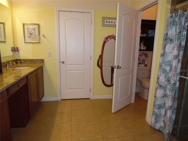 full bathroom featuring tile patterned flooring, curtained shower, baseboards, toilet, and vanity