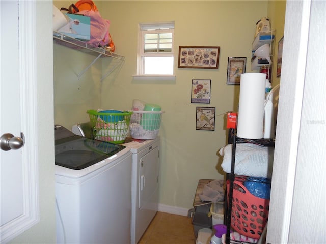 laundry area featuring tile patterned floors, baseboards, separate washer and dryer, and laundry area