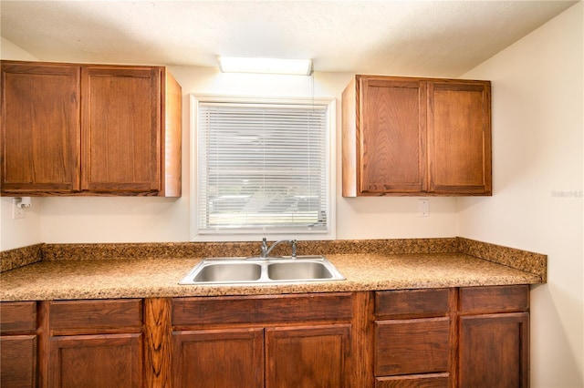 kitchen featuring a sink and brown cabinets