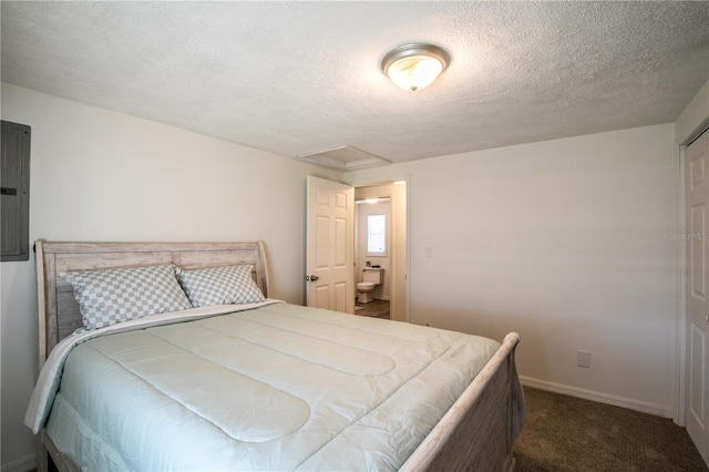 carpeted bedroom with electric panel, a textured ceiling, attic access, and baseboards