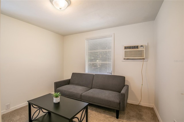 living room featuring light carpet, an AC wall unit, and baseboards