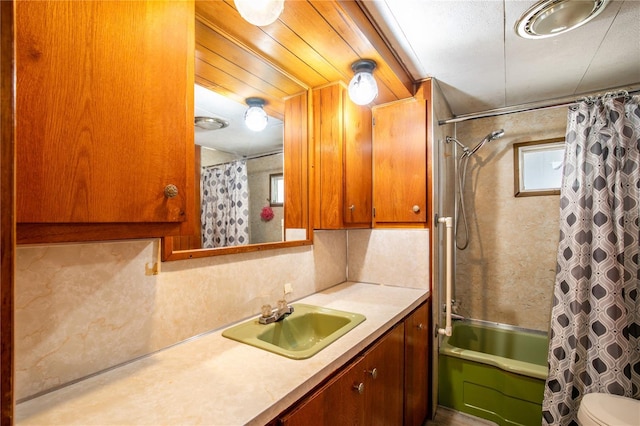 full bathroom featuring vanity, shower / tub combo, and toilet