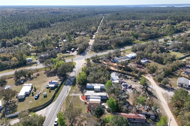 birds eye view of property featuring a view of trees