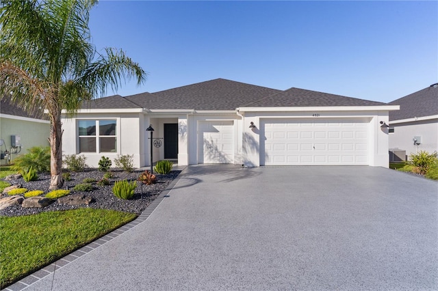 ranch-style home with stucco siding, aphalt driveway, cooling unit, an attached garage, and a shingled roof