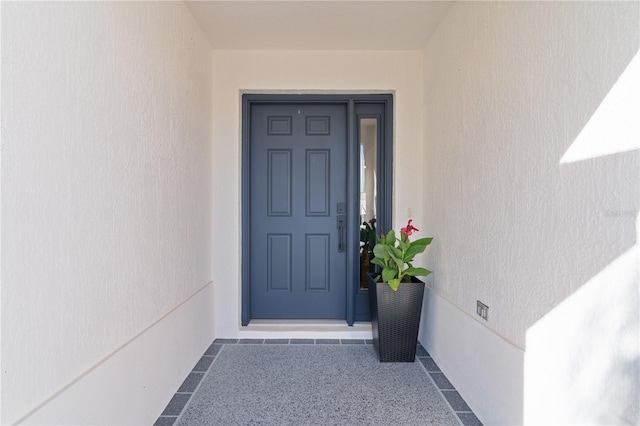 property entrance featuring stucco siding