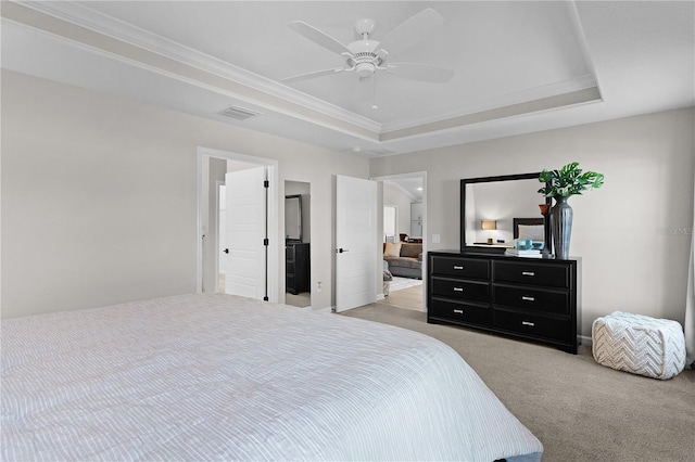 bedroom featuring a raised ceiling, crown molding, light colored carpet, and visible vents