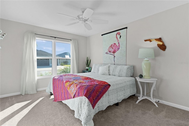 bedroom with baseboards, ceiling fan, and carpet flooring