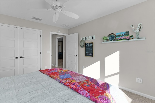 carpeted bedroom featuring visible vents, baseboards, a closet, and ceiling fan